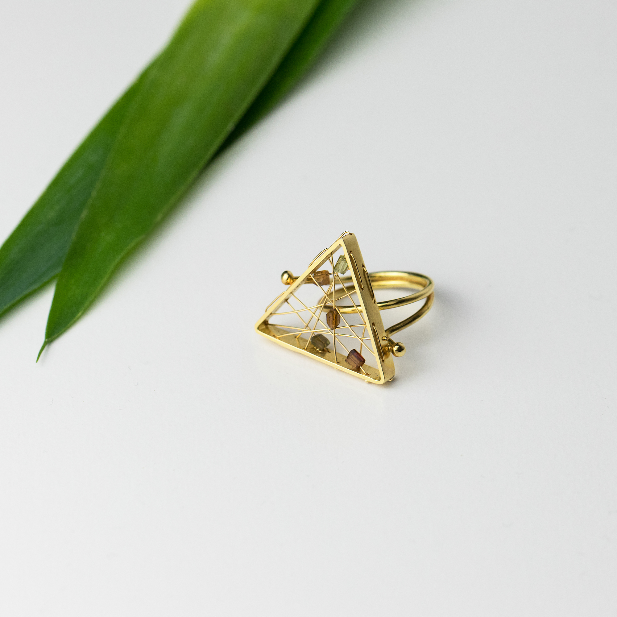 Τriangular-shaped gold ring with 5 tourmalines in brownish colours (gemstones) woven into impressively thin gold webs