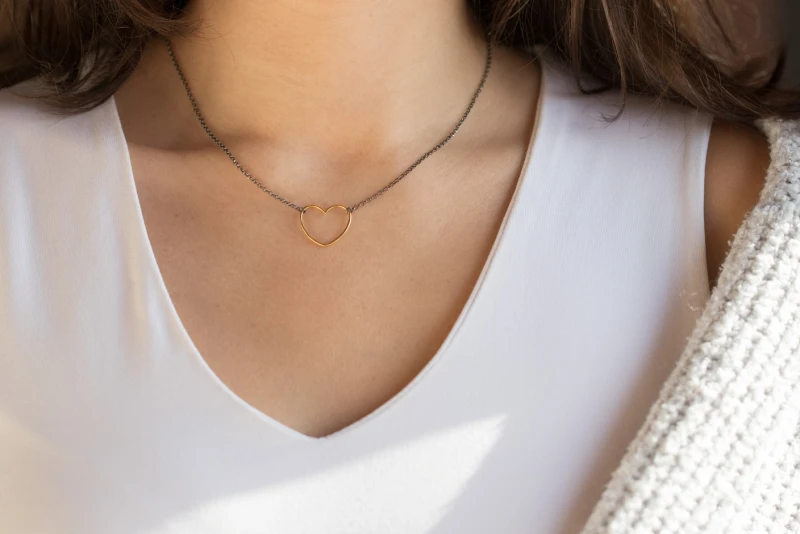 Νecklace with a delicate black chain that blends harmoniously with a gold minimalist heart